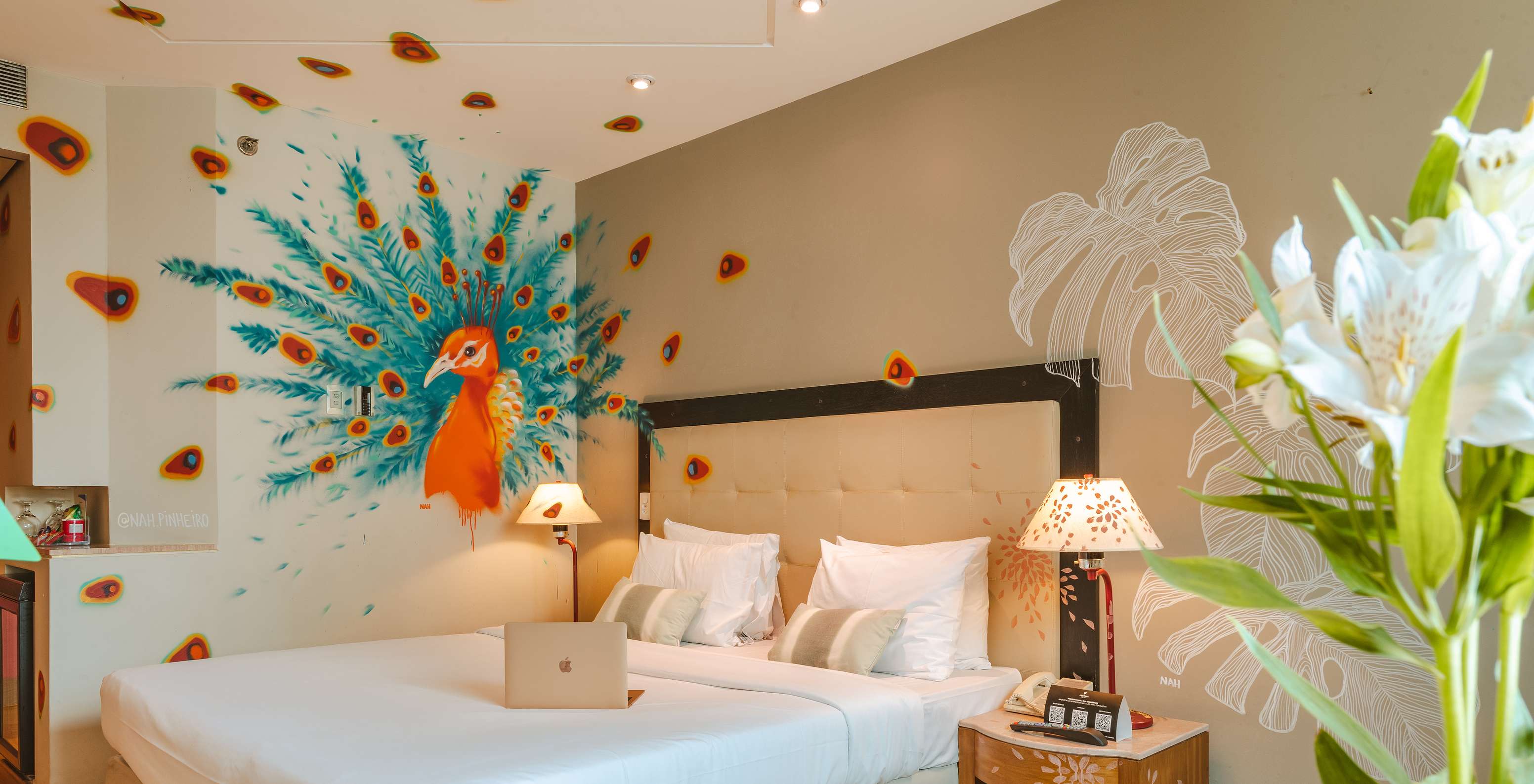 Zimmer dekoriert von der Künstlerin Nah Pinheiro mit einem bunten Pfau an der Wand, in einem 4-Sterne-Hotel in São Paulo