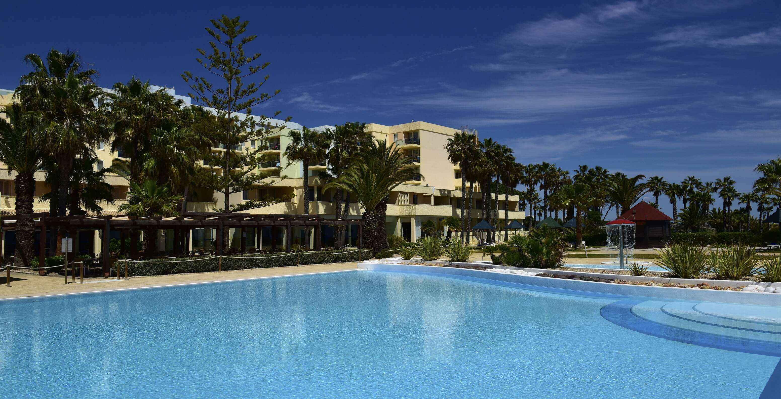 Außenpool des Pestana Viking, umgeben von Palmen und einer Bar für leichte Mahlzeiten