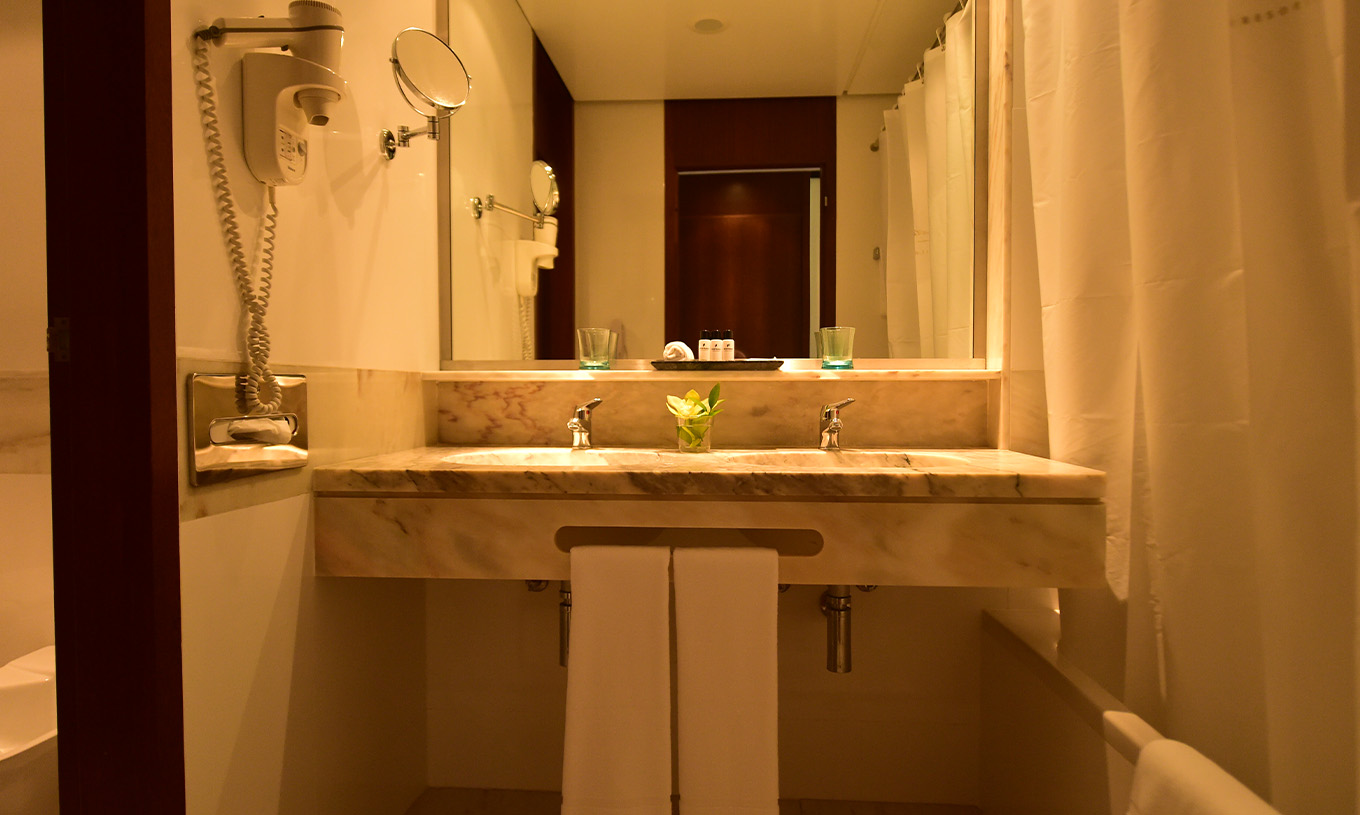 Das Klassische Zimmer mit seitlichem Meerblick im Pestana Casino Park hat ein Badezimmer mit Marmorlavabo, Badewanne und Fön