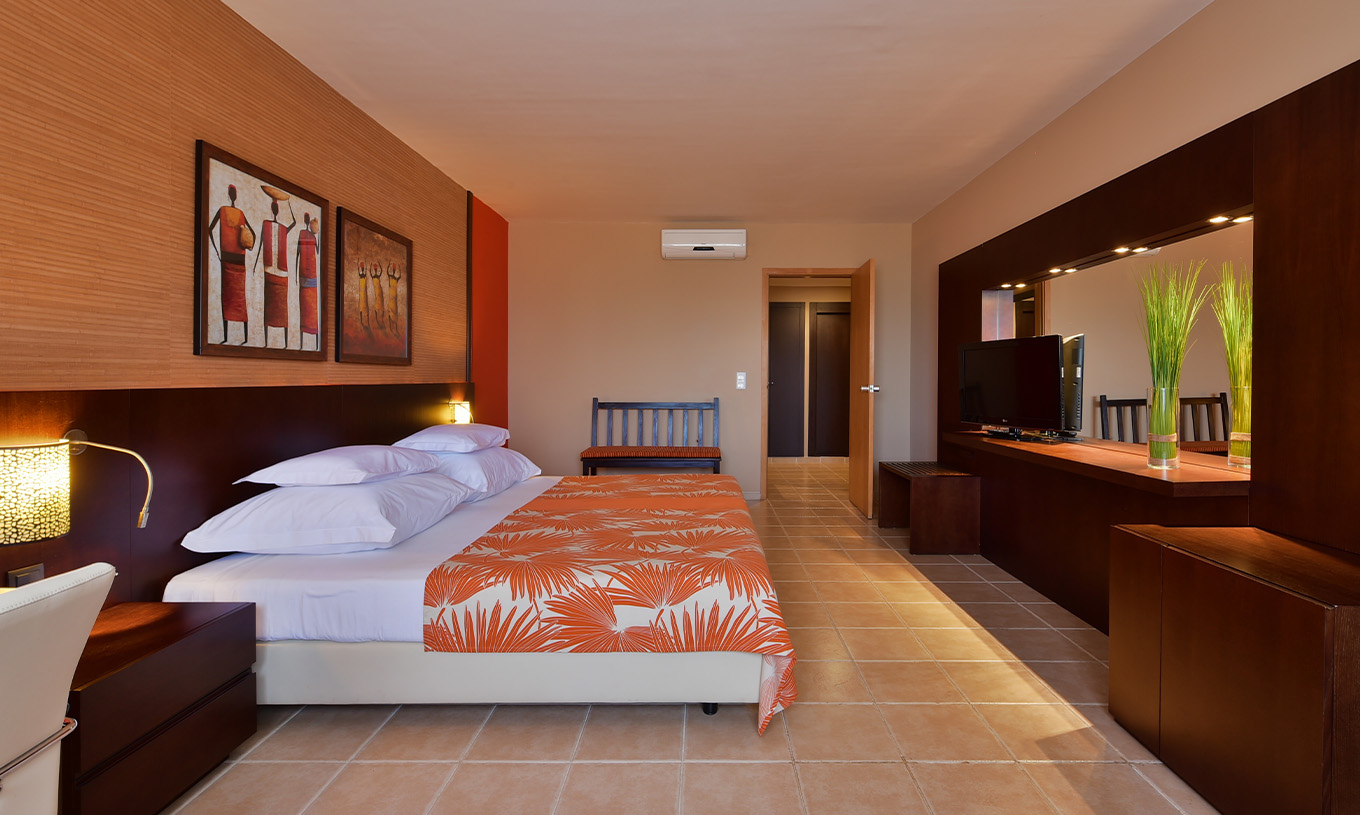 The Classic Sea View room at Pestana Tropico features a double bed, television, bedside table, mirror, and air conditioning