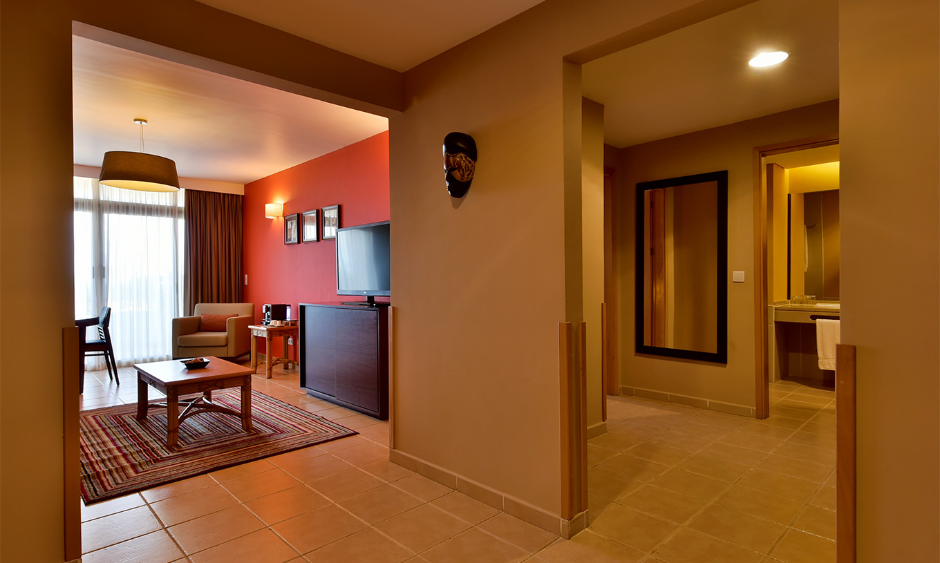 The Suite at Pestana Tropico features a living room with television and a bathroom