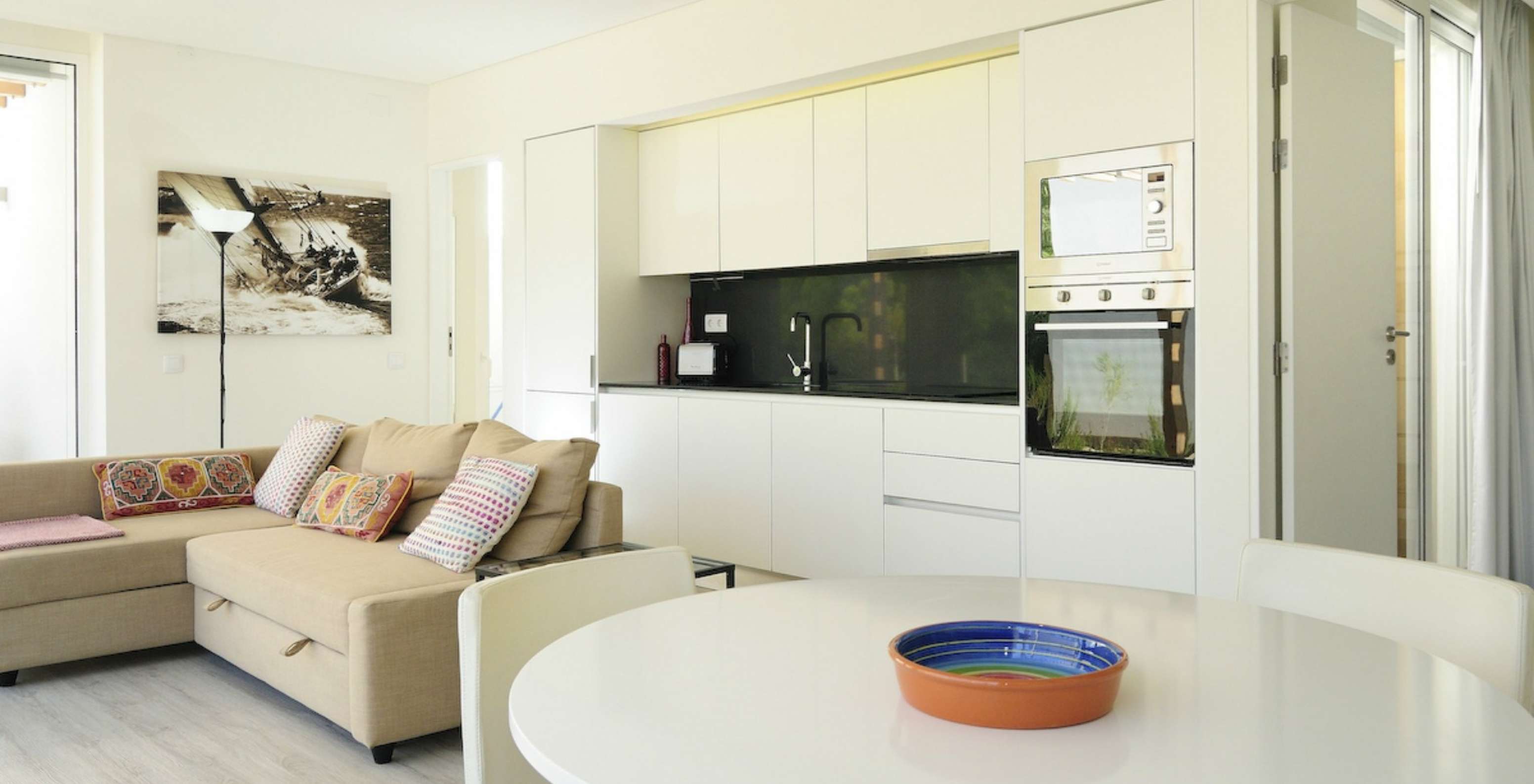 The Green T3 Villa with Private Pool of Pestana Tróia Eco Resort has a room combined with the kitchen, sofa, and dining table