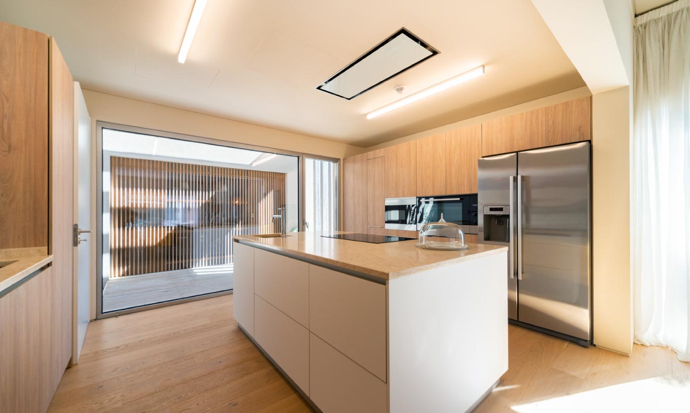 The exclusive villa with a pool at Pestana Tróia Eco Resort has a kitchen with wooden cabinets and a central island