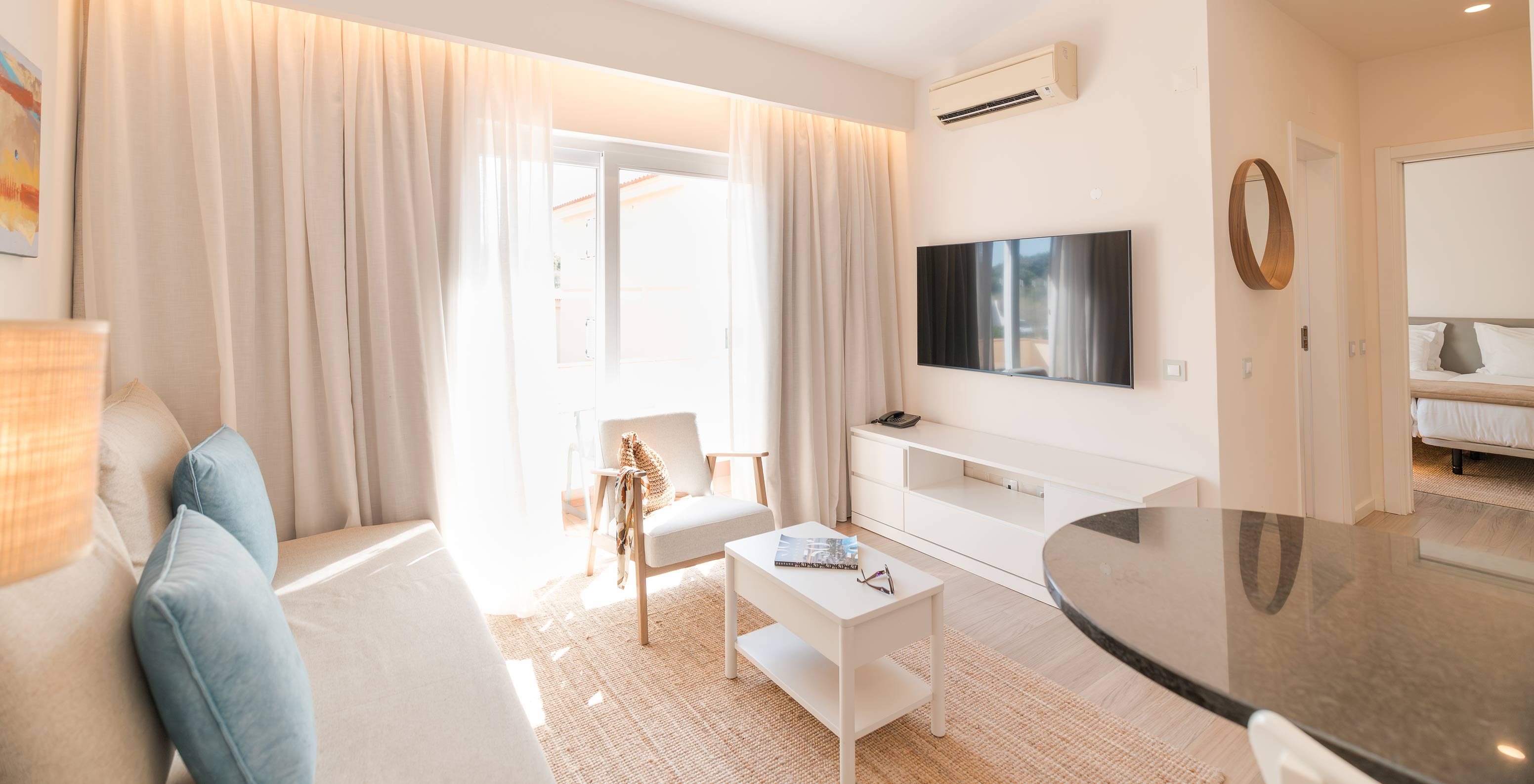 Villa 1 Bedroom Garden View at Pestana Alvor Beach Villas has a living room with sofa, TV, air conditioning and balcony