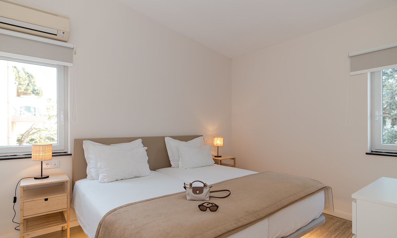Villa 2 Bedrooms Garden View at Pestana Alvor Beach Villas has a bedroom with two beds, two windows and air conditioning