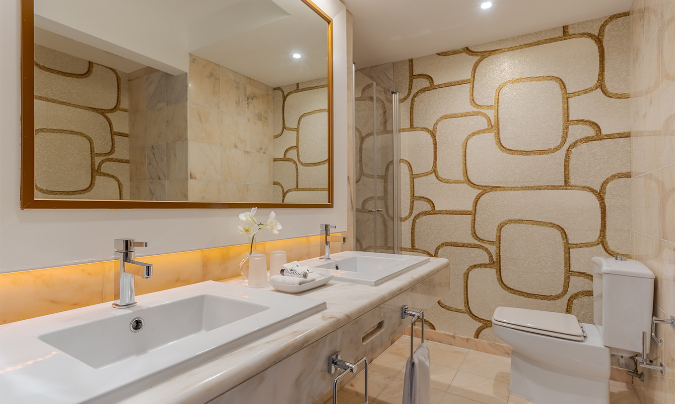 The Sea View Deluxe at Pestana Alvor Praia has a marble bathroom with two sinks, a large mirror, and toilet