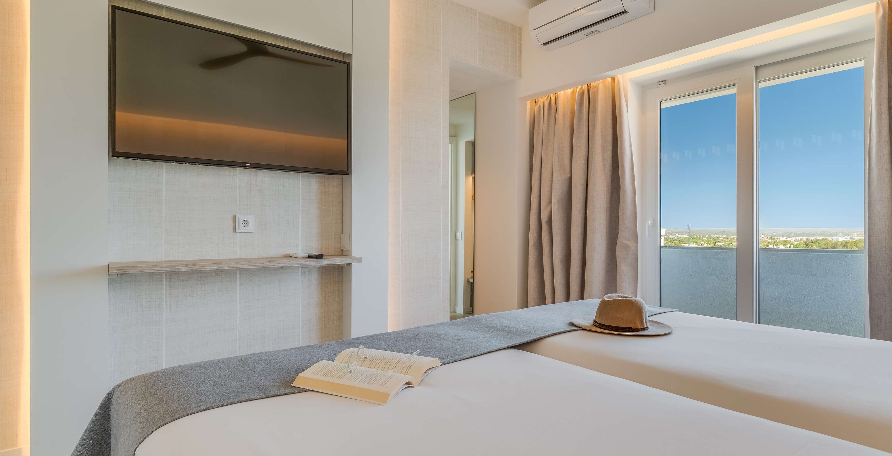 The Classic Garden View Room at Pestana Blue Alvor Beach has two beds, a TV, air conditioning, and a balcony with a view