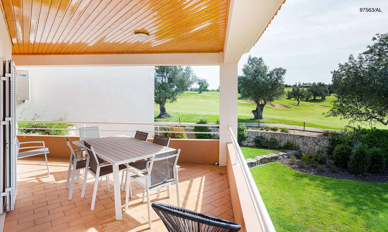The Pestana Carvoeiro Golf T3 Superior Apartment has a balcony with tables and chairs, with garden views