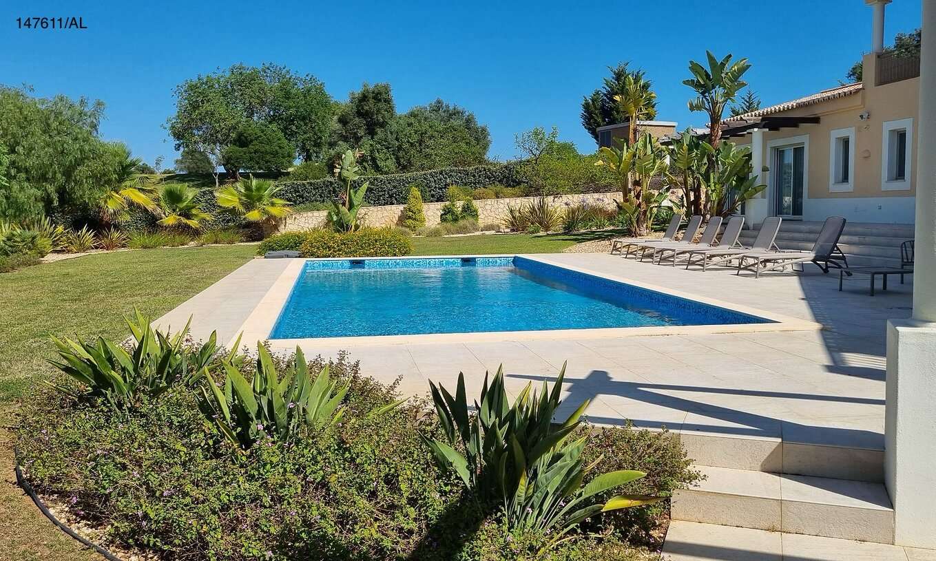 The Pestana Carvoeiro Golf V5 Superior Villa has an exterior patio with a pool, grass, and loungers