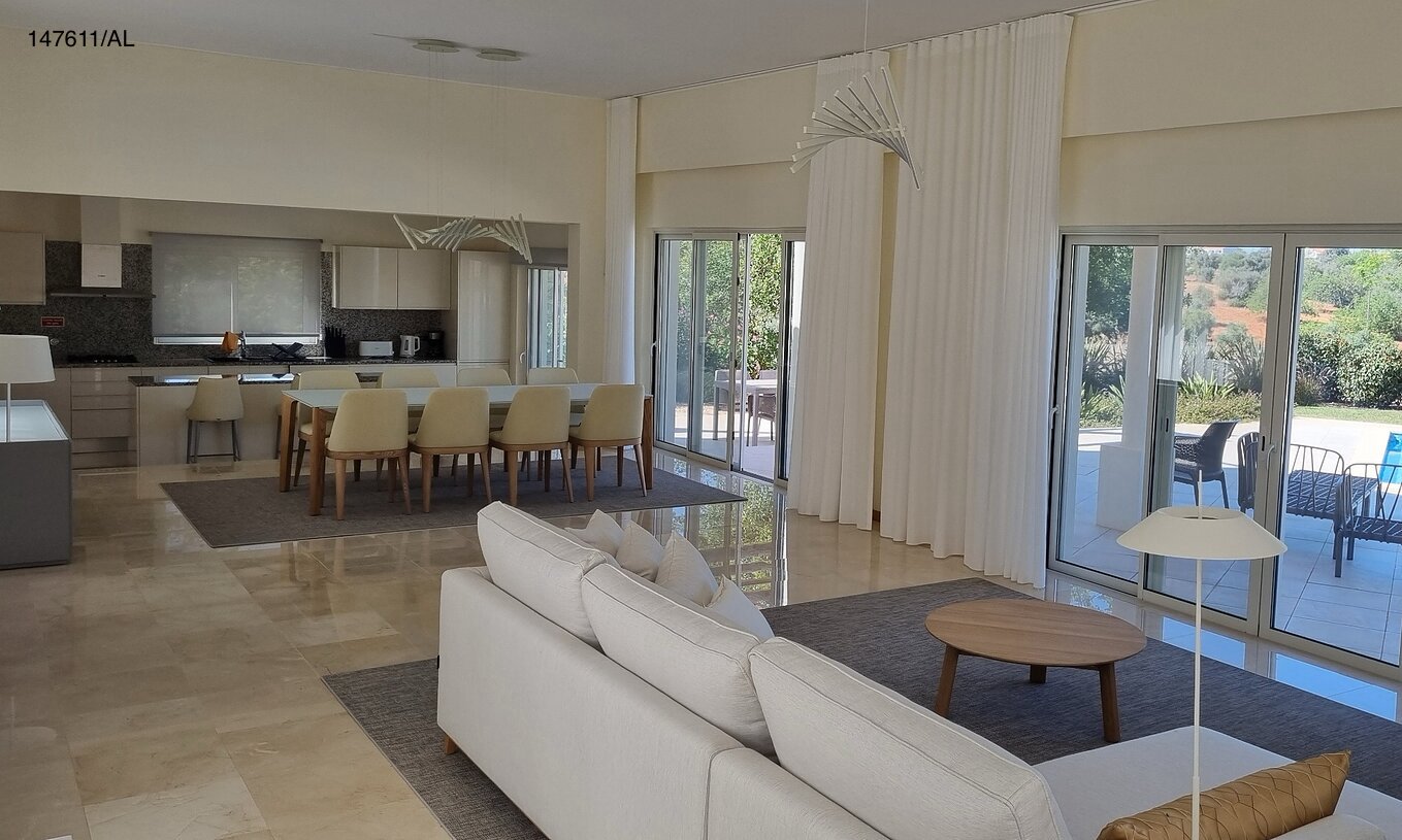 The Pestana Carvoeiro Golf V5 Superior Villa has a living room with a sofa, TV, and exterior view