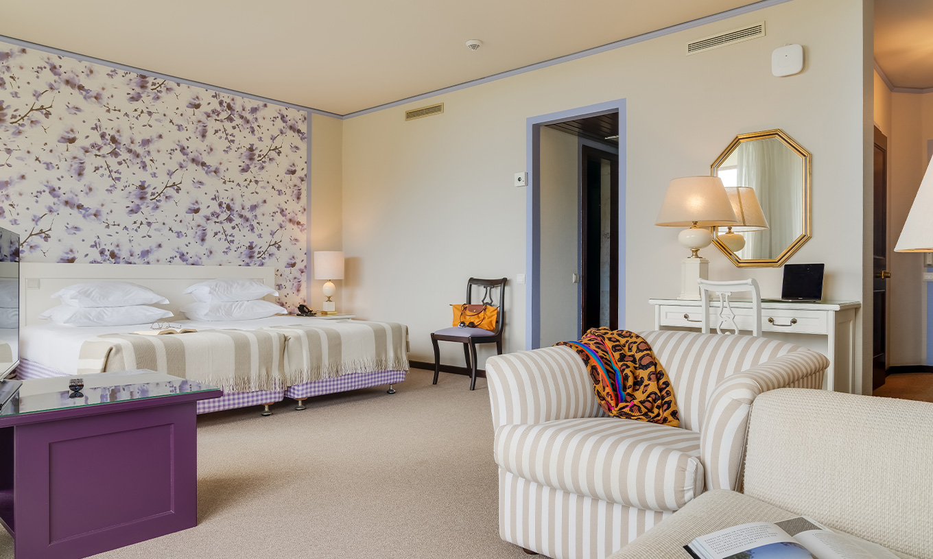Junior Garden View Suite at Pestana Bahia Praia has a spacious area with two single beds, a sofa and a chair