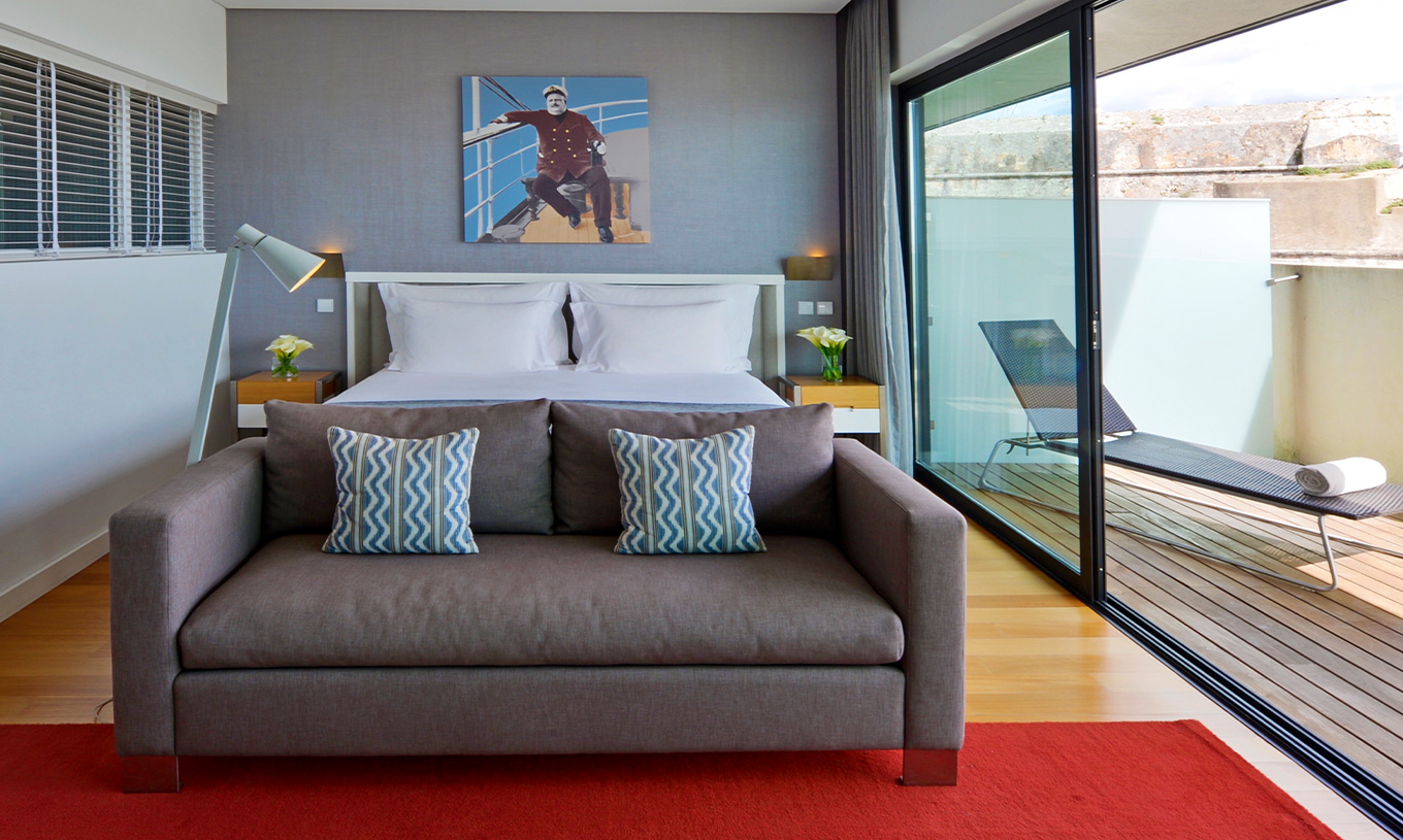The Superior Double Room at Pestana Cidadela Cascais has a painting on the wall, a double bed, and a comfortable sofa