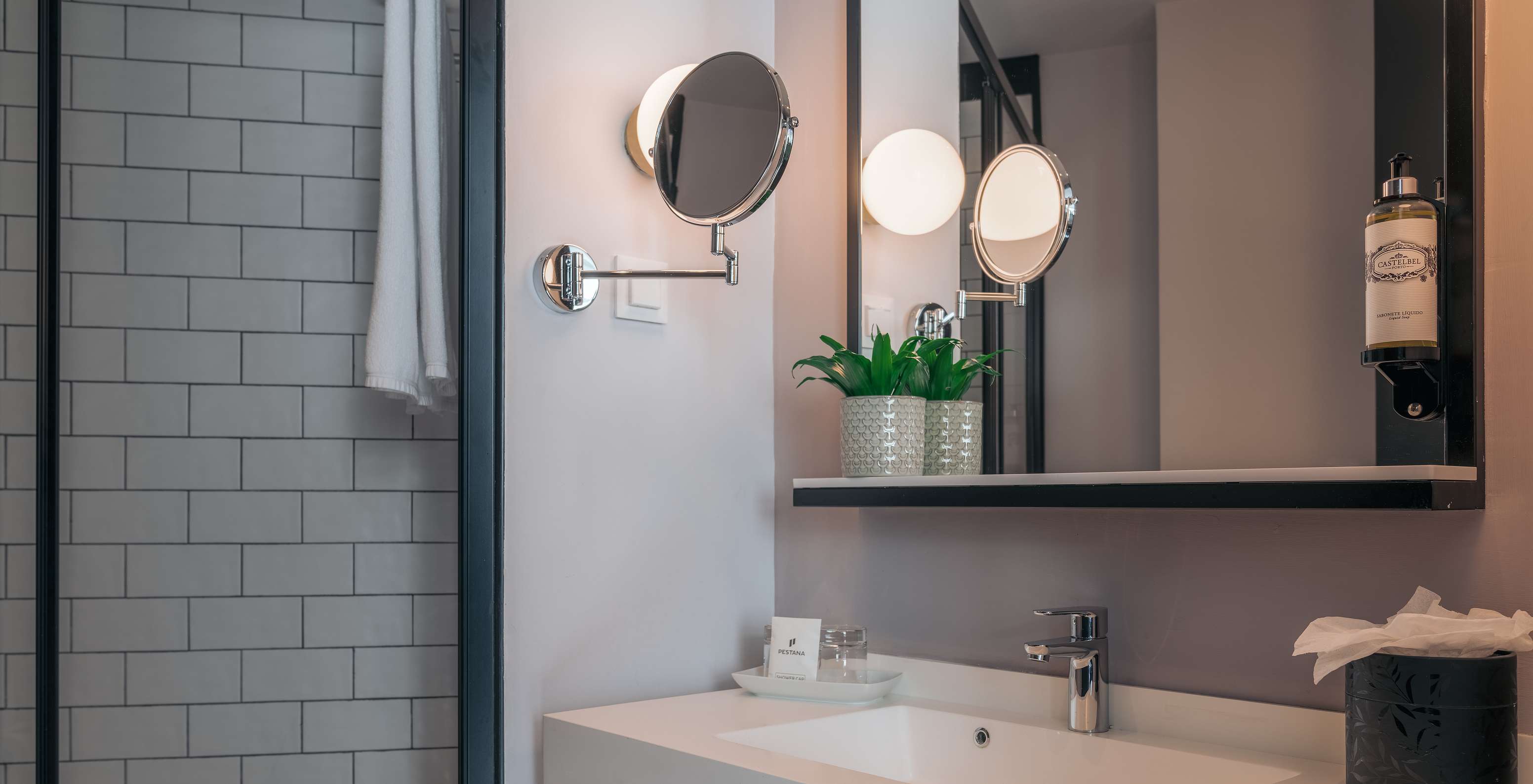 The Double Superior Room at Pestana Lisboa Vintage has a bathroom with sink with two mirrors and a side shower