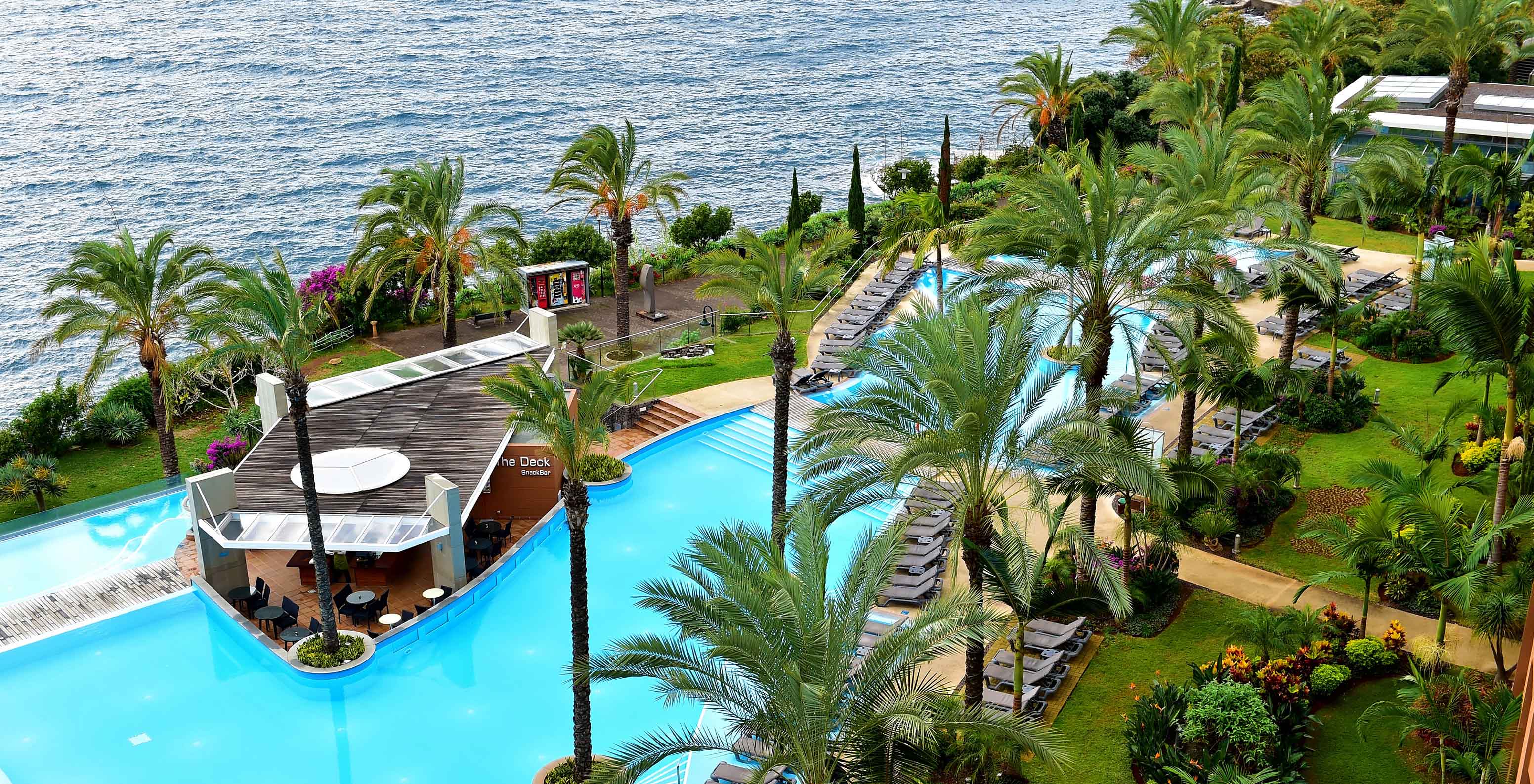 Outdoor pool and gardens at Pestana Promenade, hotel in Madeira, near the beach and Lido, with sea view