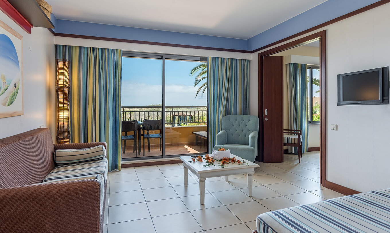 The T1 Suite Apartment of Pestana Porto Santo All Inclusive has a living room with access to the balcony, with garden view