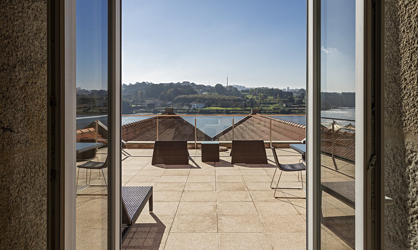 The Suite Nasoni has a large balcony with two tables, chairs, and a sun lounger
