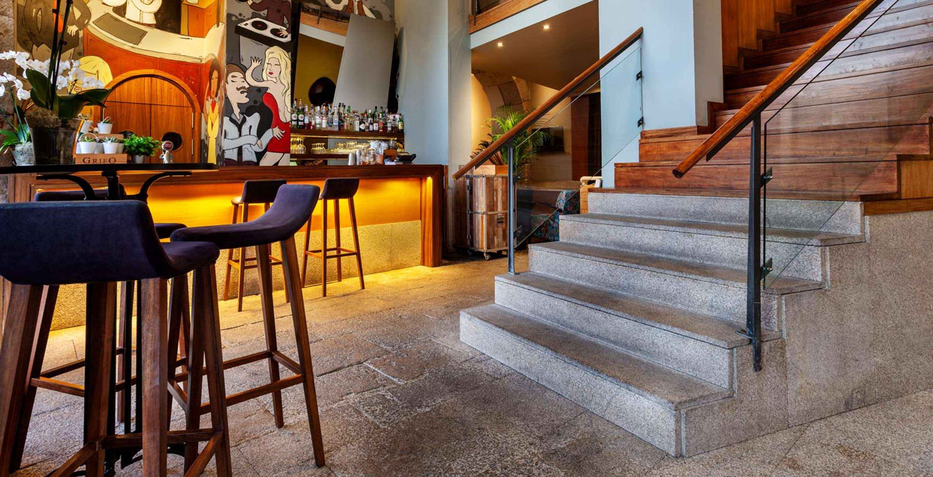 Bar with patterned walls near the stairs at Pestana Vintage Porto, a hotel at Praça da Ribeira in Porto