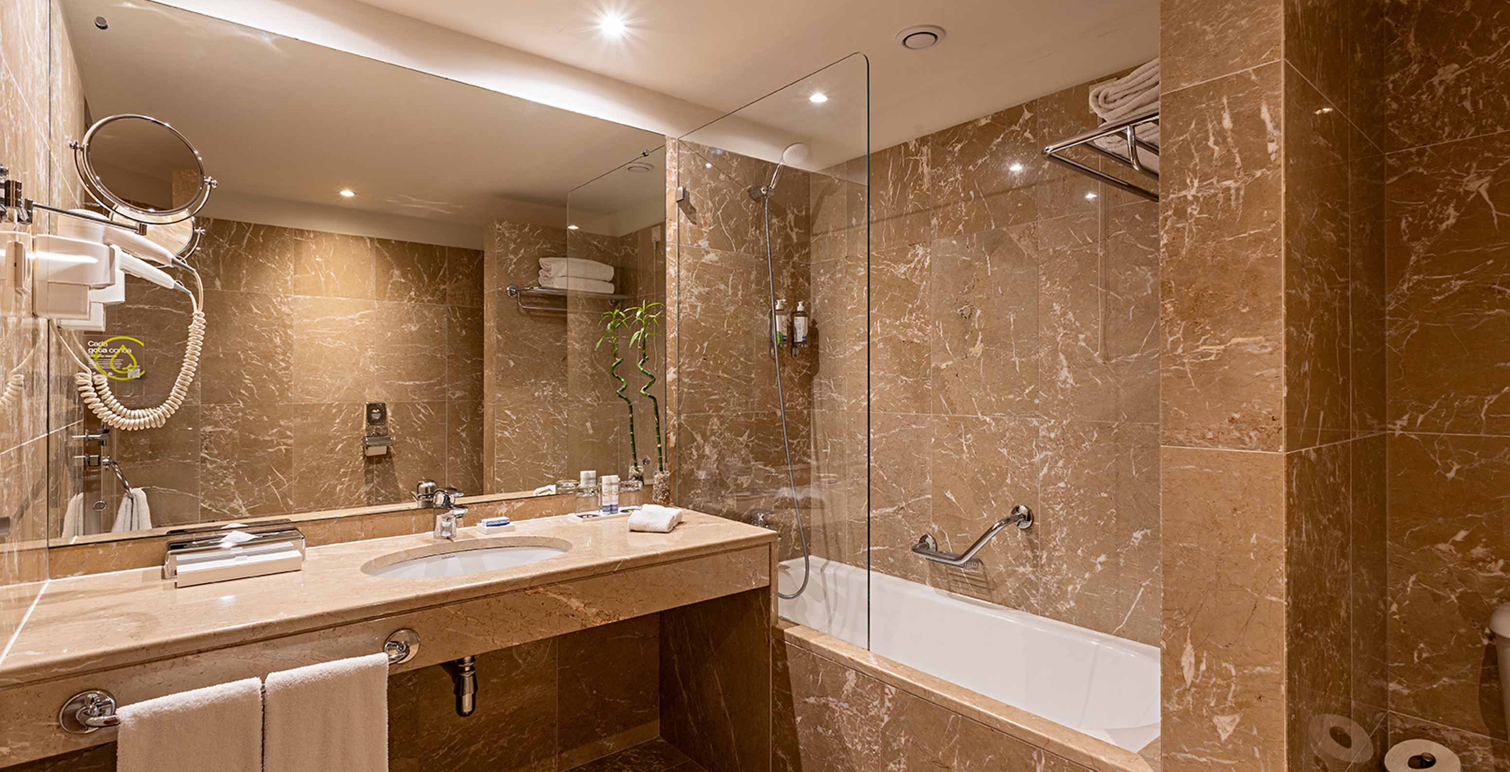 The Suite Grand View at Pestana Vintage Porto has a bathroom with brown marble walls and a bathtub