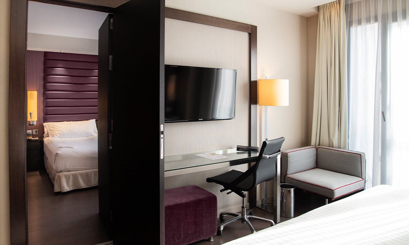 Large Family Room at Pestana Arena Barcelona has two rooms with connecting doors, and two double beds in each room