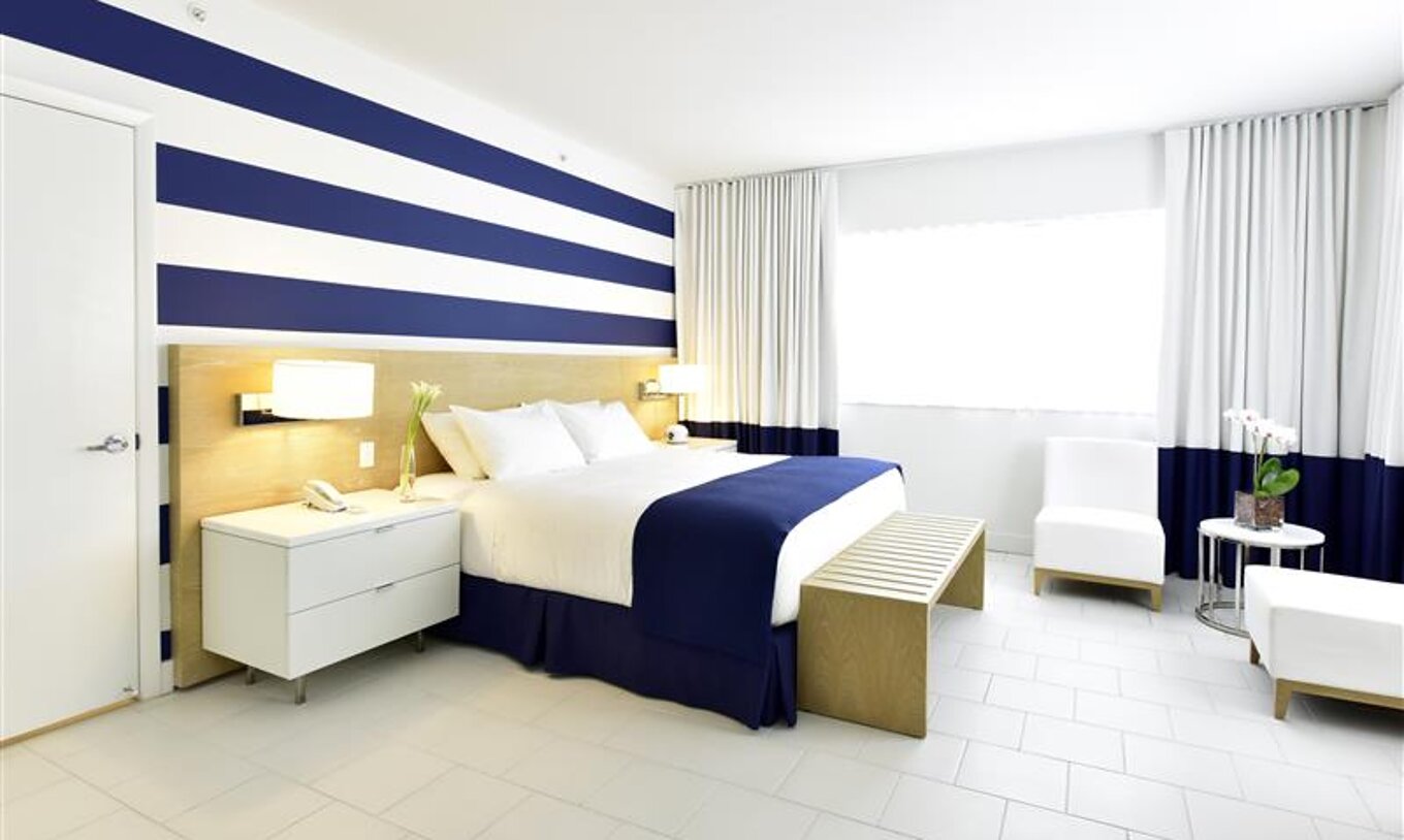 Superior King at Pestana Miami South Beach: modern room with king bed, blue-white décor.