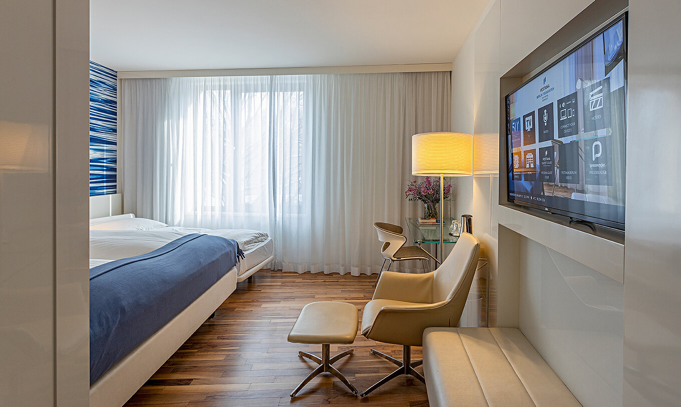 Family Deluxe has a desk, lounge chair and TV