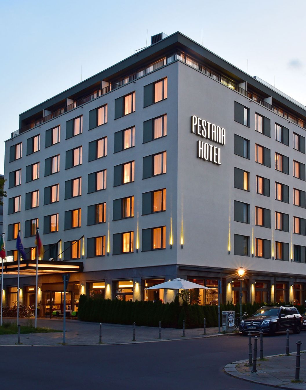 Exterior view of Pestana Berlin, a 4-star hotel in the center, illuminated by the hotel’s façade lights