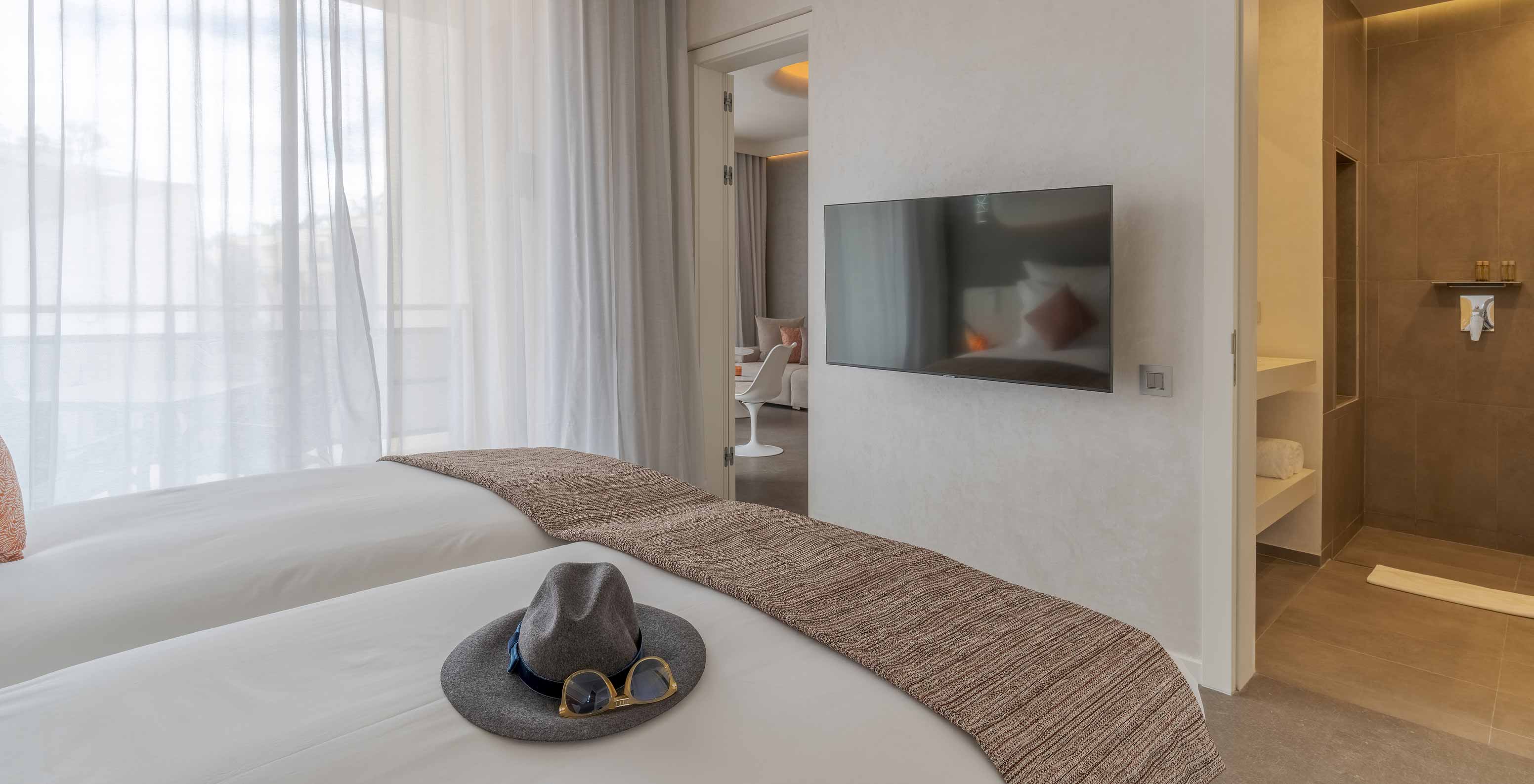 The CR7 Room Avenue at Pestana CR7 Marrakech has a double bed, a table, and a large window with a view of M Avenue