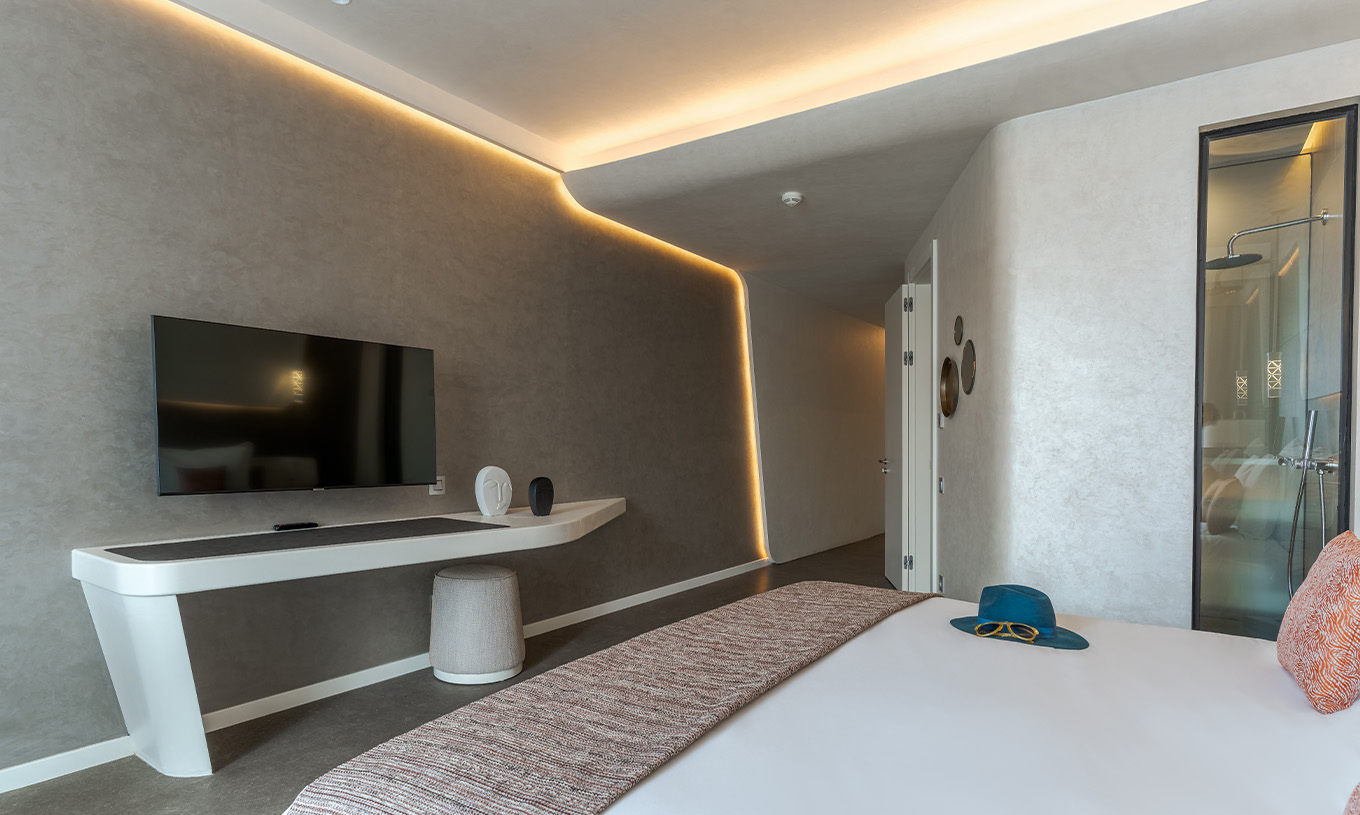 The CR7 Room at Pestana CR7 Marrakech has a TV, a modern desk, and lights illuminating the wall corners