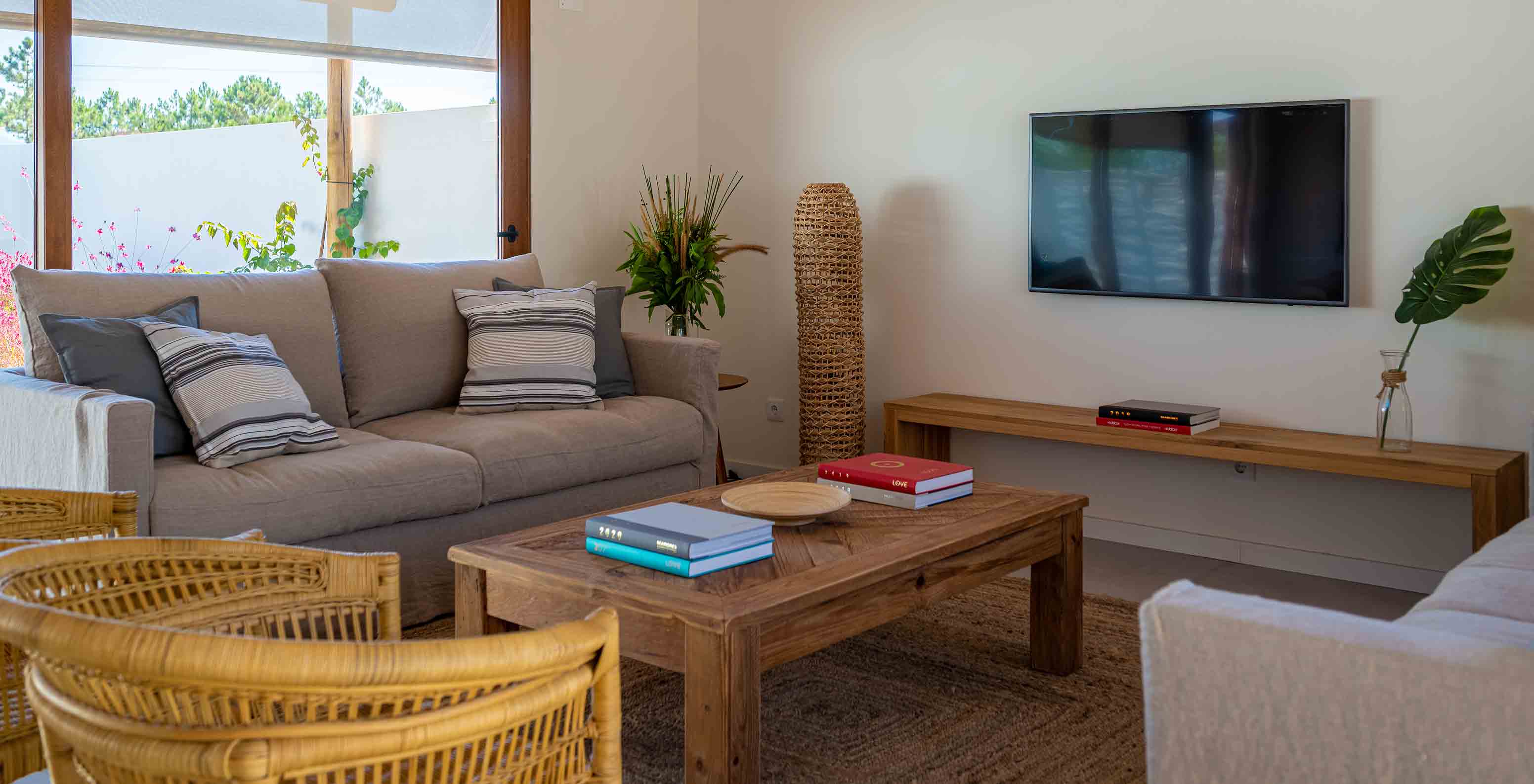 The Standard Villa at Pestana Comporta Village Residences has a living room with a sofa and a TV on the wall
