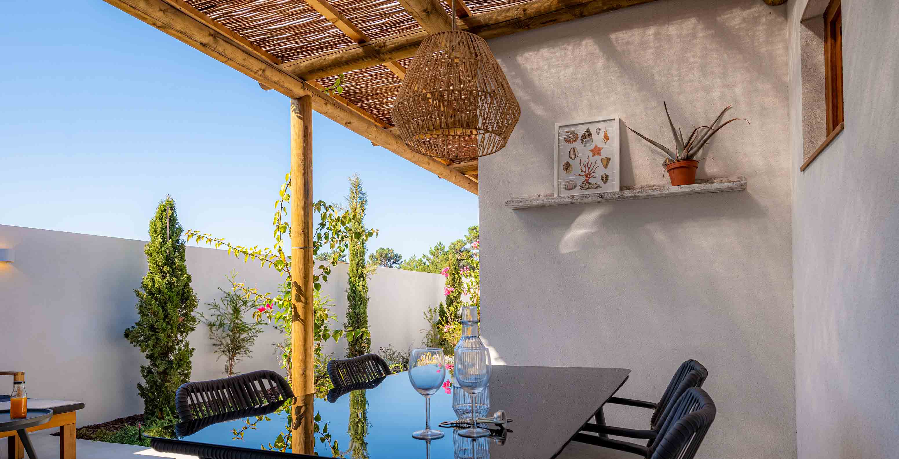 The Standard Villa at Pestana Comporta Village Residences has an outdoor dining table under a pergola