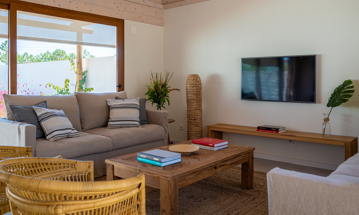 The Standard Green Villa at Pestana Comporta Village Residences has a living room with a sofa and a TV on the wall