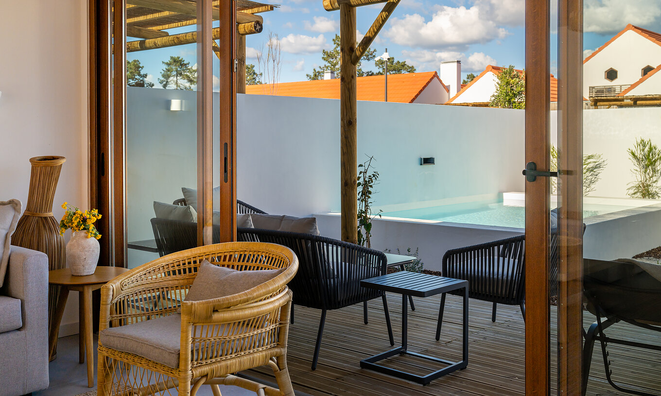 The Superior Villa at Pestana Comporta Village Residences has a terrace with a pool, chairs, and an outdoor table