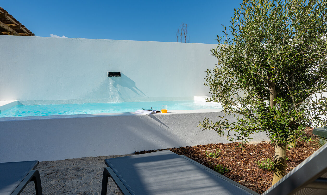 The Superior Villa at Pestana Comporta Village Residences has a pool with a waterfall and several sun loungers