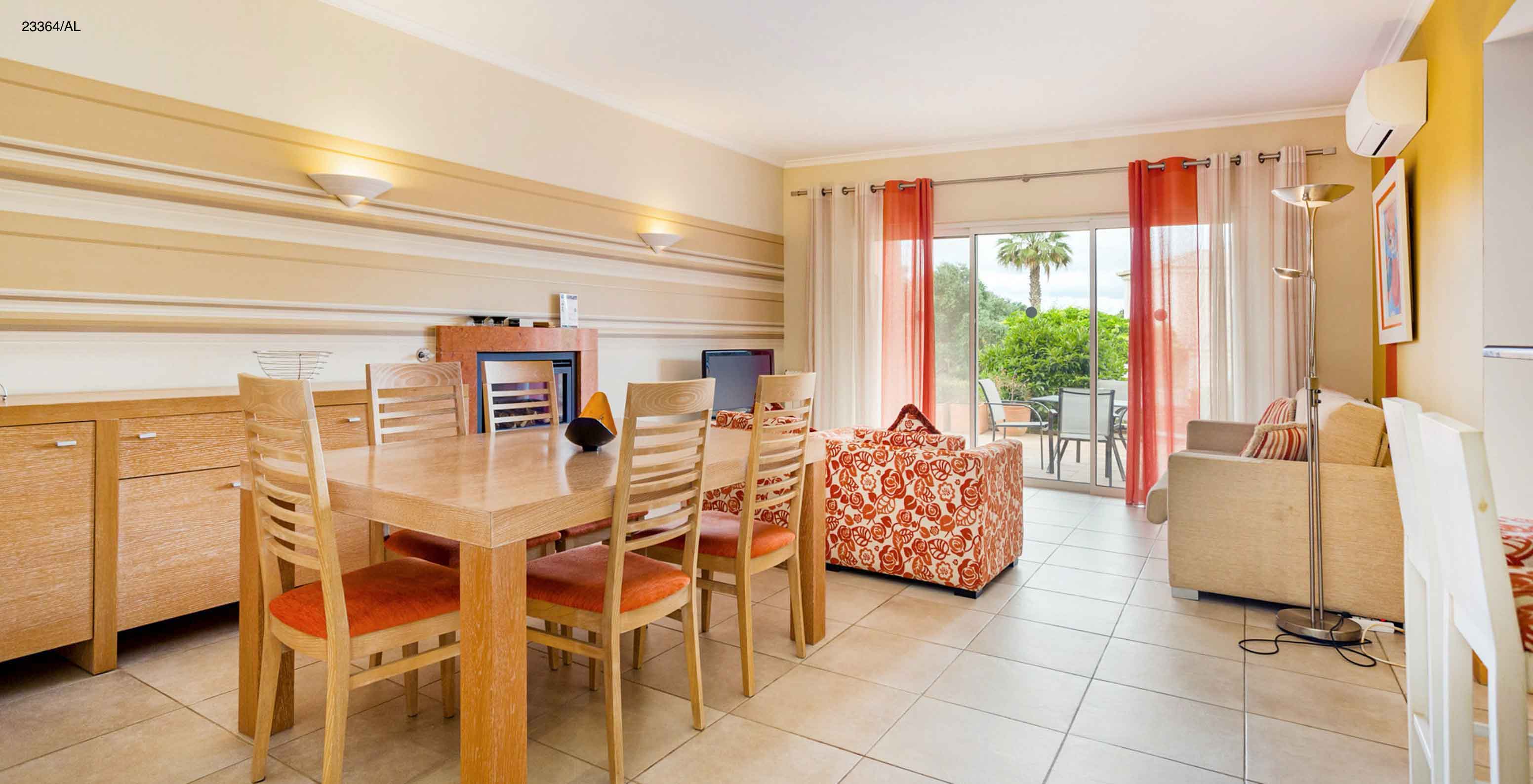 The Pestana Carvoeiro Golf T1 Standard Apartment has a dining room with five chairs and a sofa