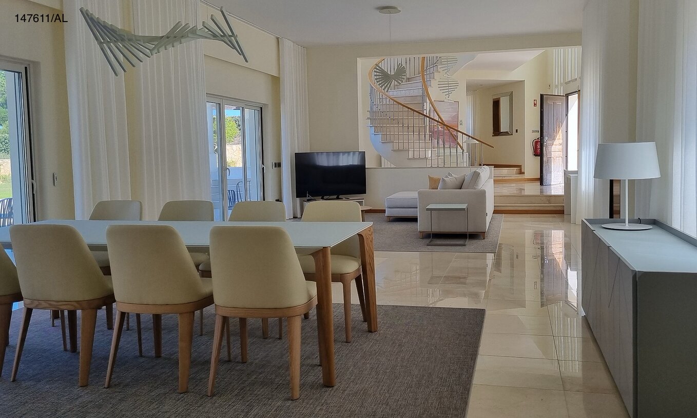 The Pestana Carvoeiro Golf V5 Superior Villa has a spacious living room with a dining table, chairs, and TV