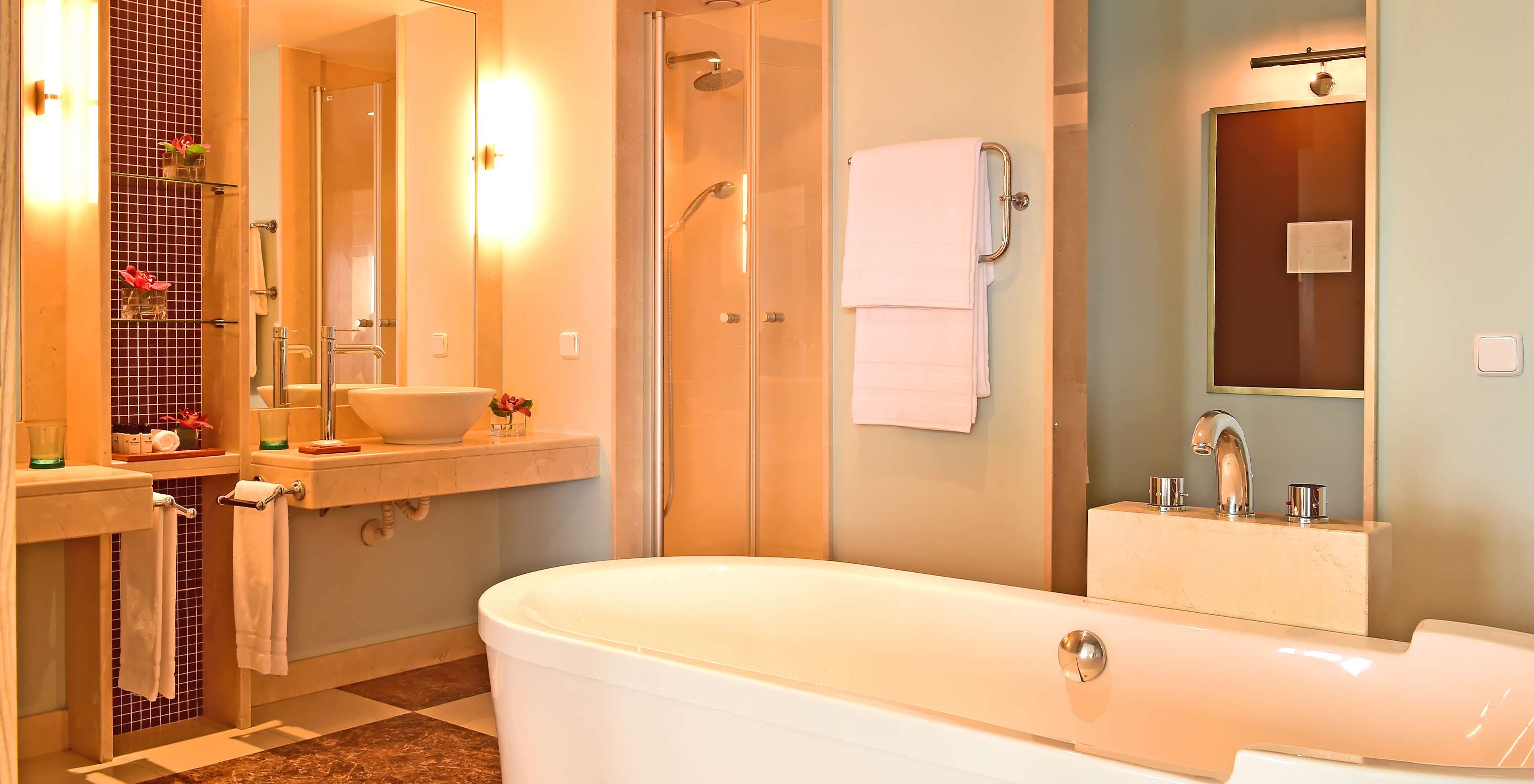 The Junior Suite at Pestana Carlton Madeira has a bathroom with a bathtub, sink, and decorative elements