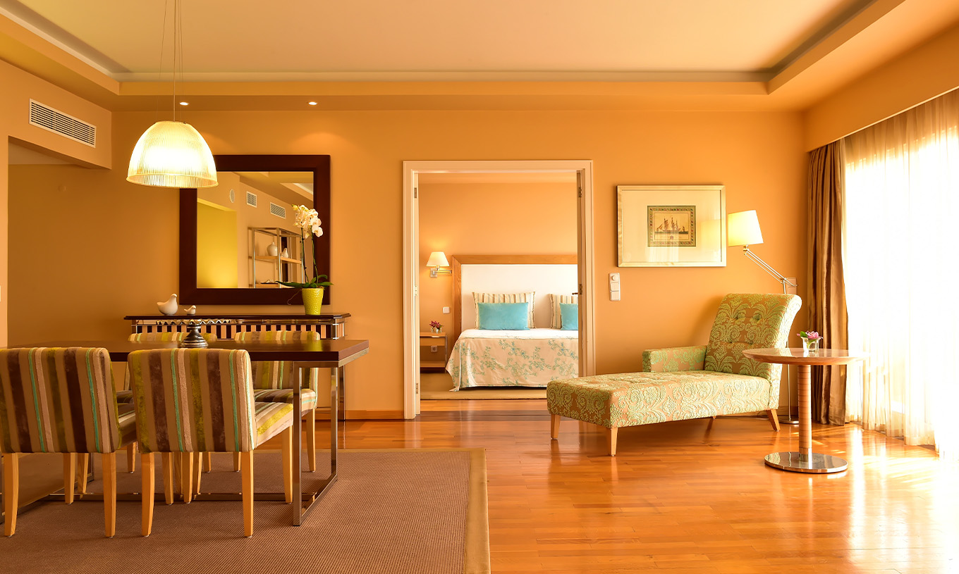 The Presidential Suite at Pestana Carlton Madeira has a spacious area with dining, a chaise longue, and a double bed