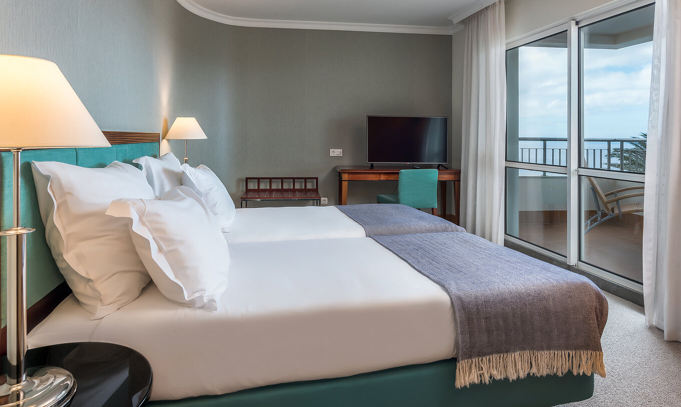 The Standard Suite Sea View at Pestana Grand has two single beds, TV and desk