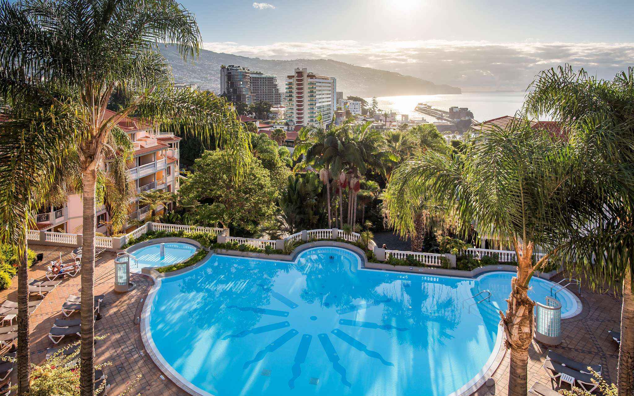 Aerial view of the pool at Pestana Miramar, a hotel in Madeira near the beach, surrounded by palm trees