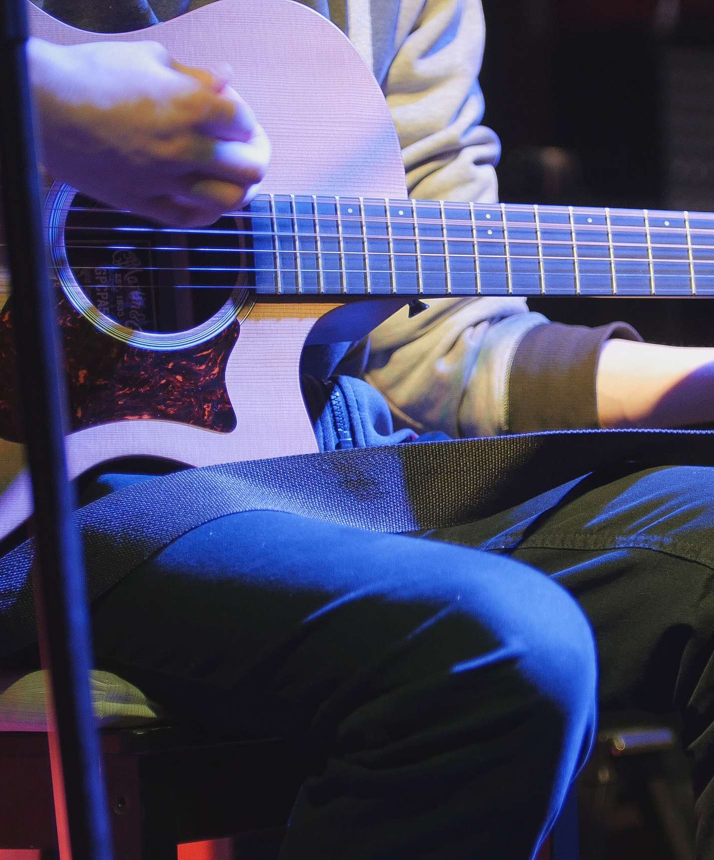 Person playing guitar in a bar at night at Pestana Quinta Perestrello, a hotel in Madeira near the beach, with a pool