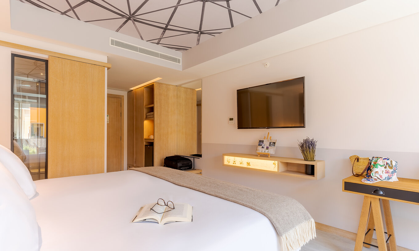 The Superior room at Pestana Douro Riverside includes a double bed, television, and wardrobe for clothes