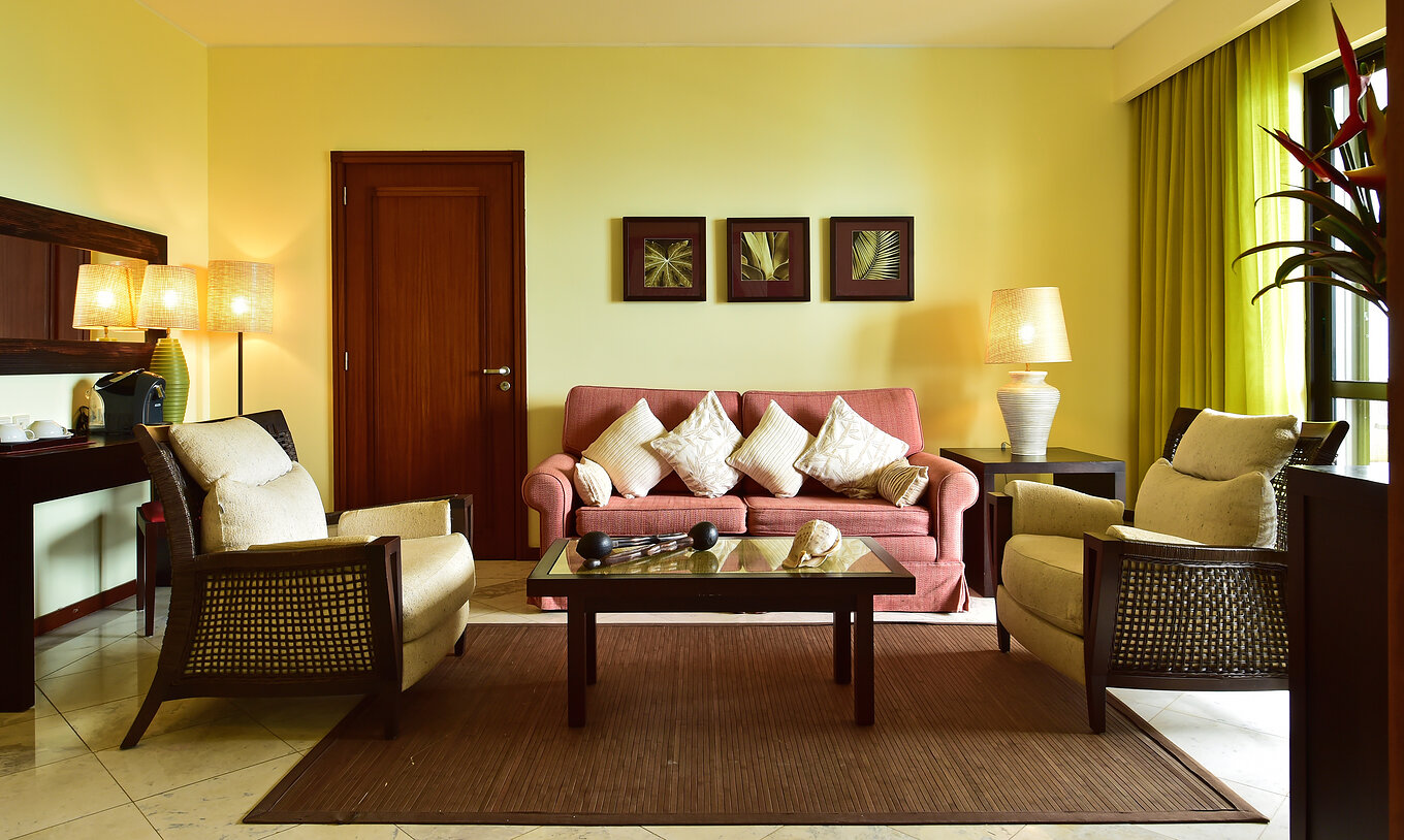 The Central Suite of Pestana São Tomé has a spacious, bright room with a double sofa and two armchairs