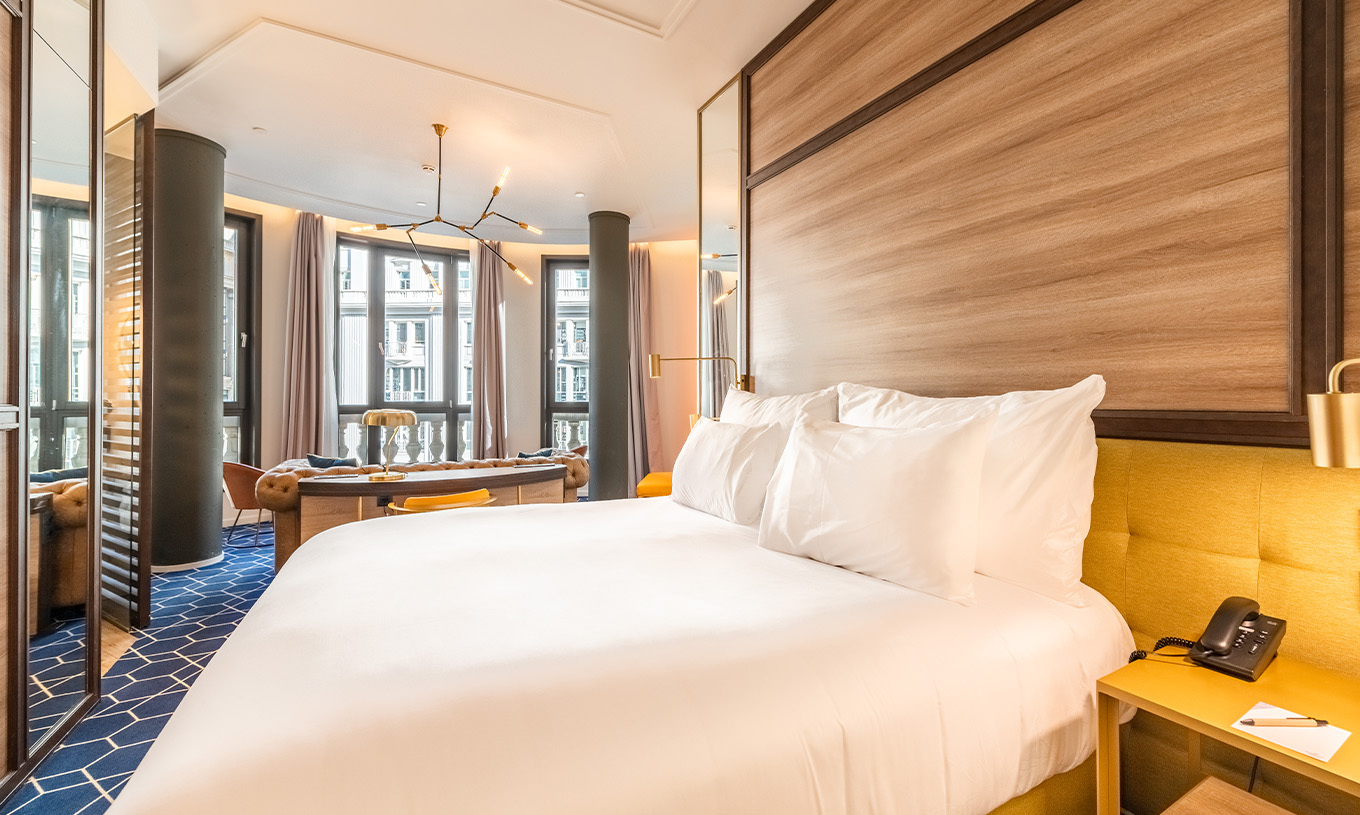 The Amazing CR7 Room at Pestana CR7 Gran Vía Madrid includes a double bed, sofa, and large panoramic windows facing Gran Vía