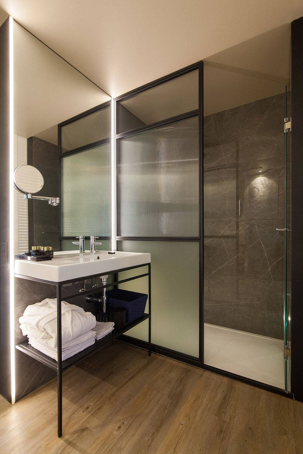 The Superior room at Pestana Collection Plaza Mayor has a bathroom with a walk-in shower, a magnifying mirror and amenities	Superior Room - Bathroom - Pestana Plaza Mayor Madrid