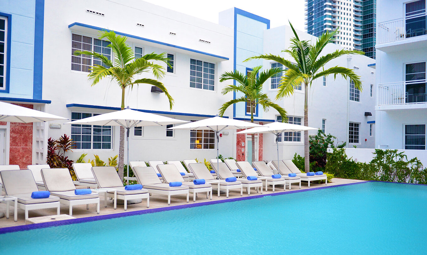 The Superior King Pool View at Pestana Miami South Beach is a modern pool with white loungers