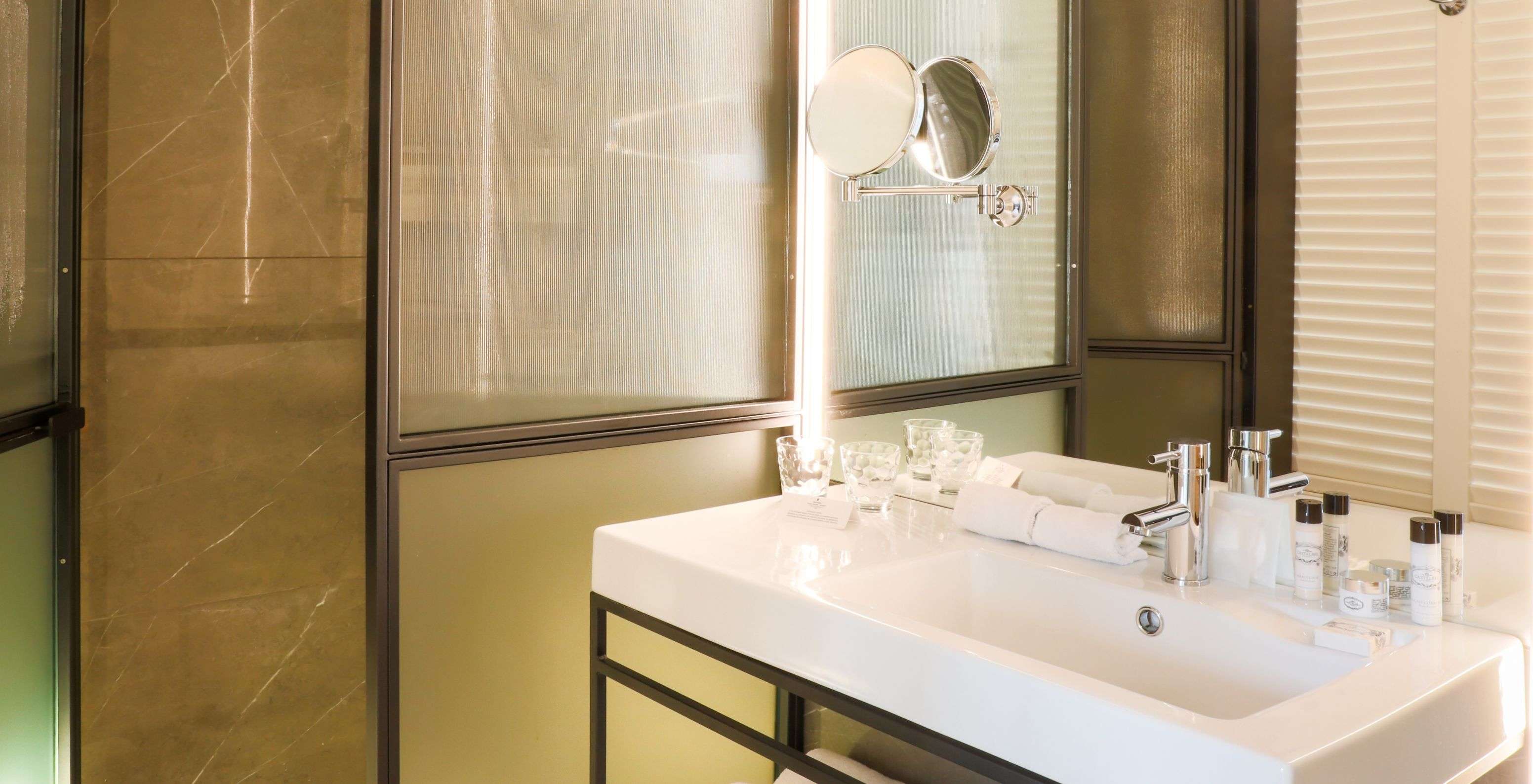 La Chambre Supérieure Plus du Pestana Collection Plaza Mayor a une salle de bain avec grand miroir et douche à l'italienne.