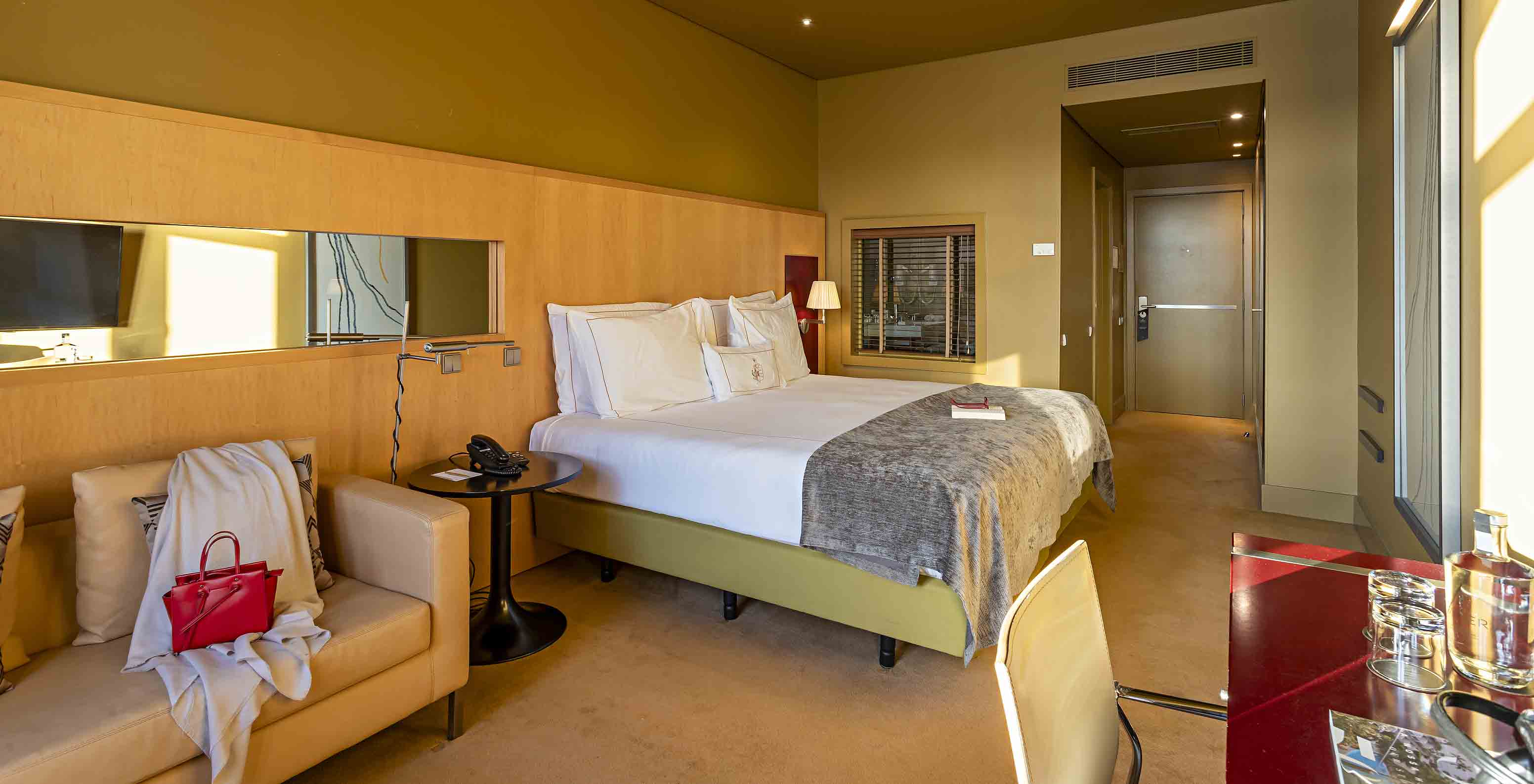 De Executive Superior heeft een tweepersoonsbed, een bank en een rood bureau