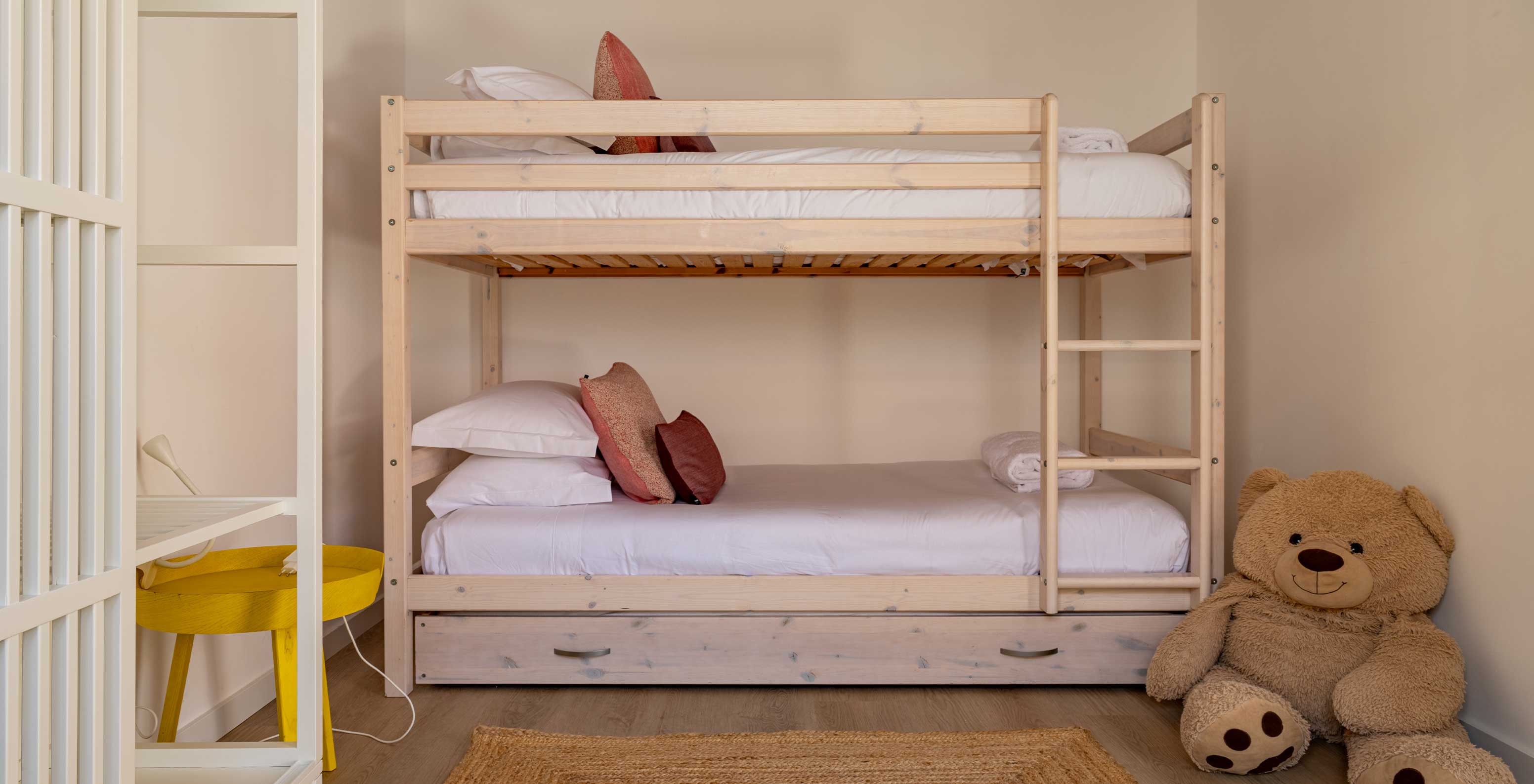 A Standard Green Villa do Pestana Comporta Village Residences tem um beliche de madeira de duas camas e um urso de peluche