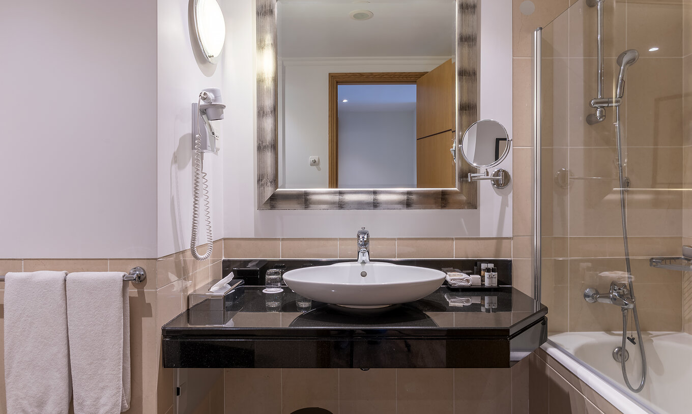 O Clássico Vista Interior do Pestana Grand tem uma casa de banho com lavatório, banheira com duche e toalha