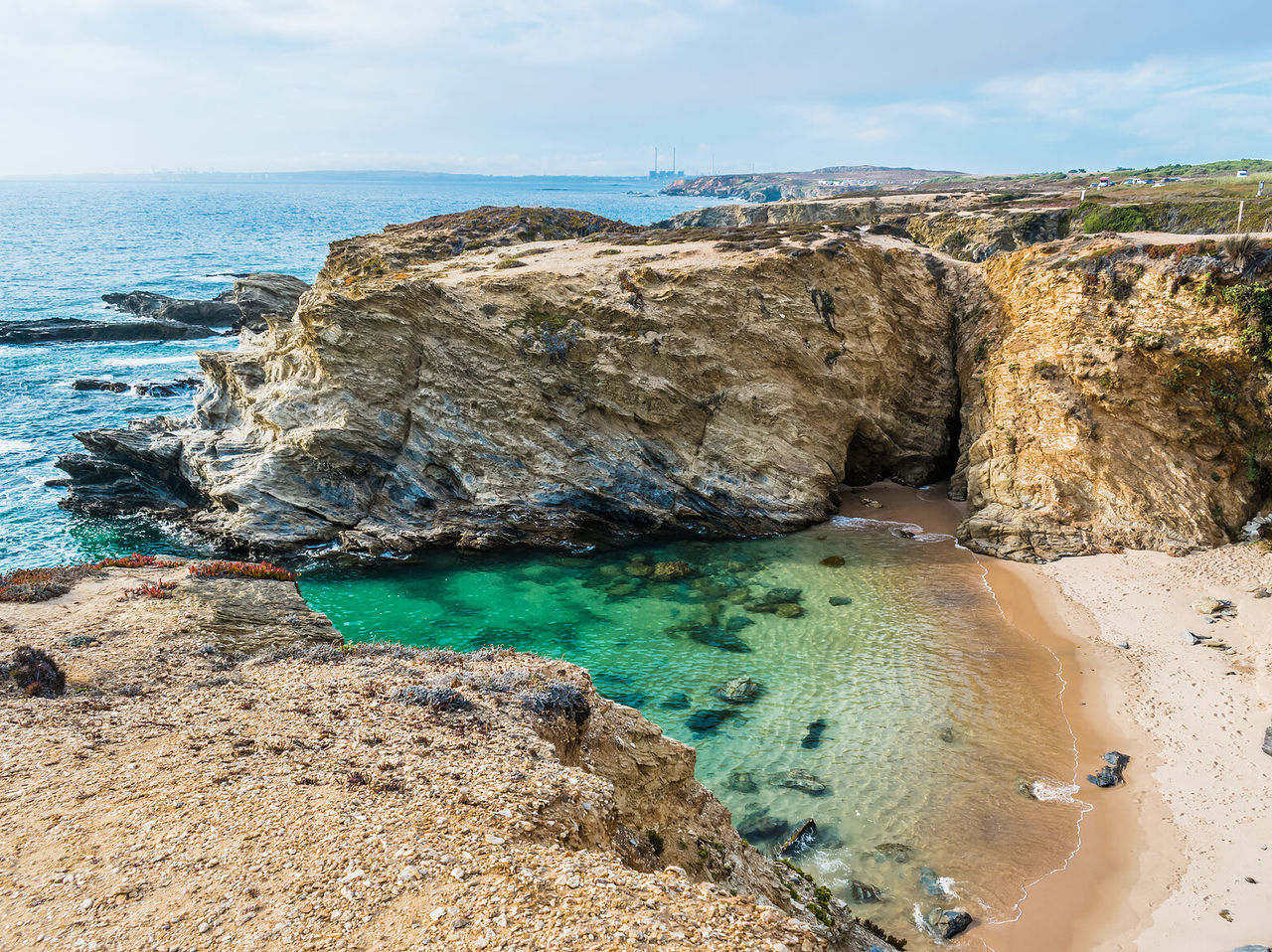 Versteckter Strand zwischen Klippen im Alentejo, mit kristallklarem Wasser und weißem Sand, ideal zum Entspannen